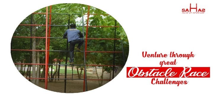 Participants crawling and climbing in the obstacle race at Sahas